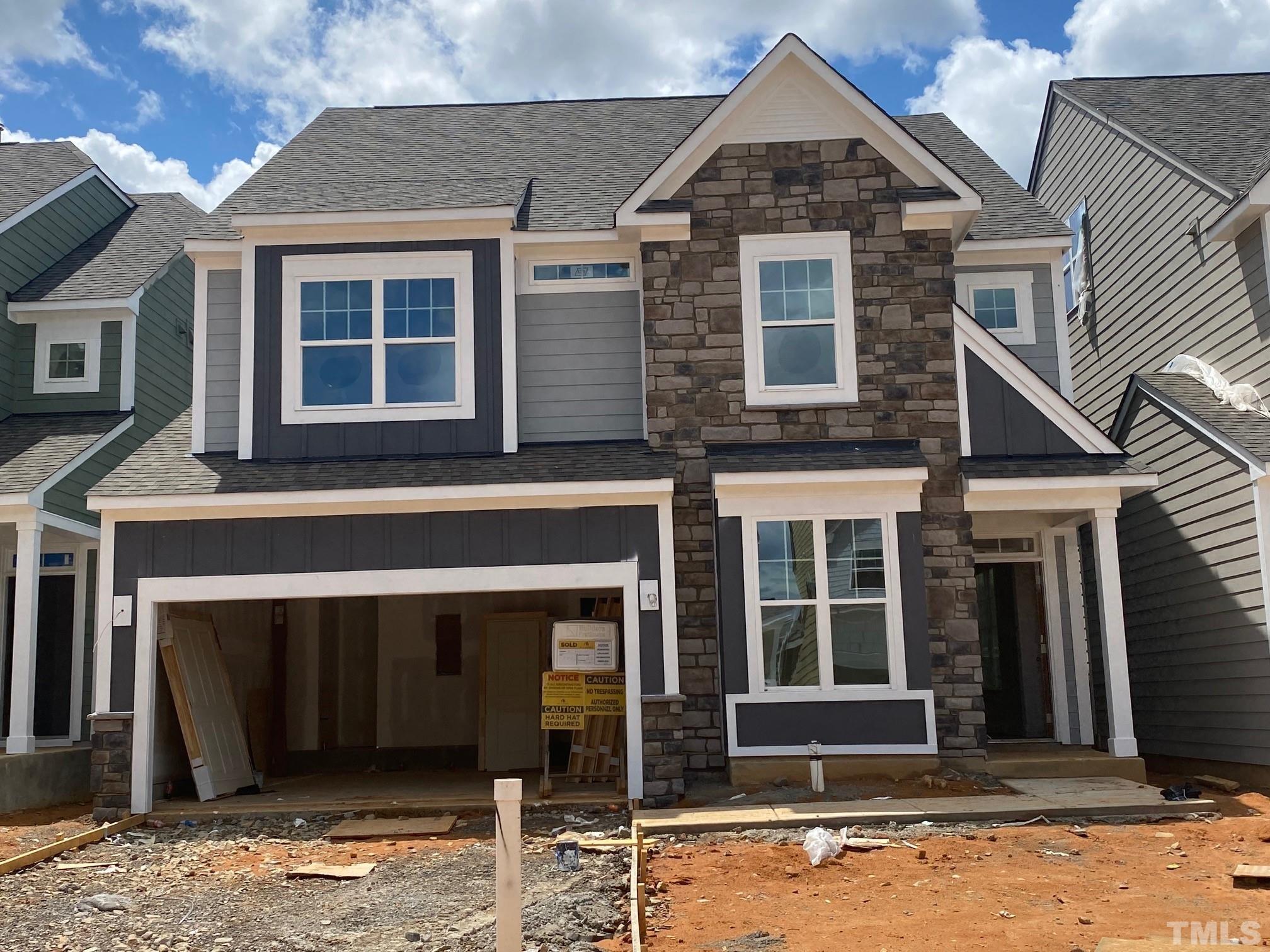 405 Ressler Street, Unit 550 Holly Springs, NC 27540 - Photo 1 of 1 a front view of a house with a yard