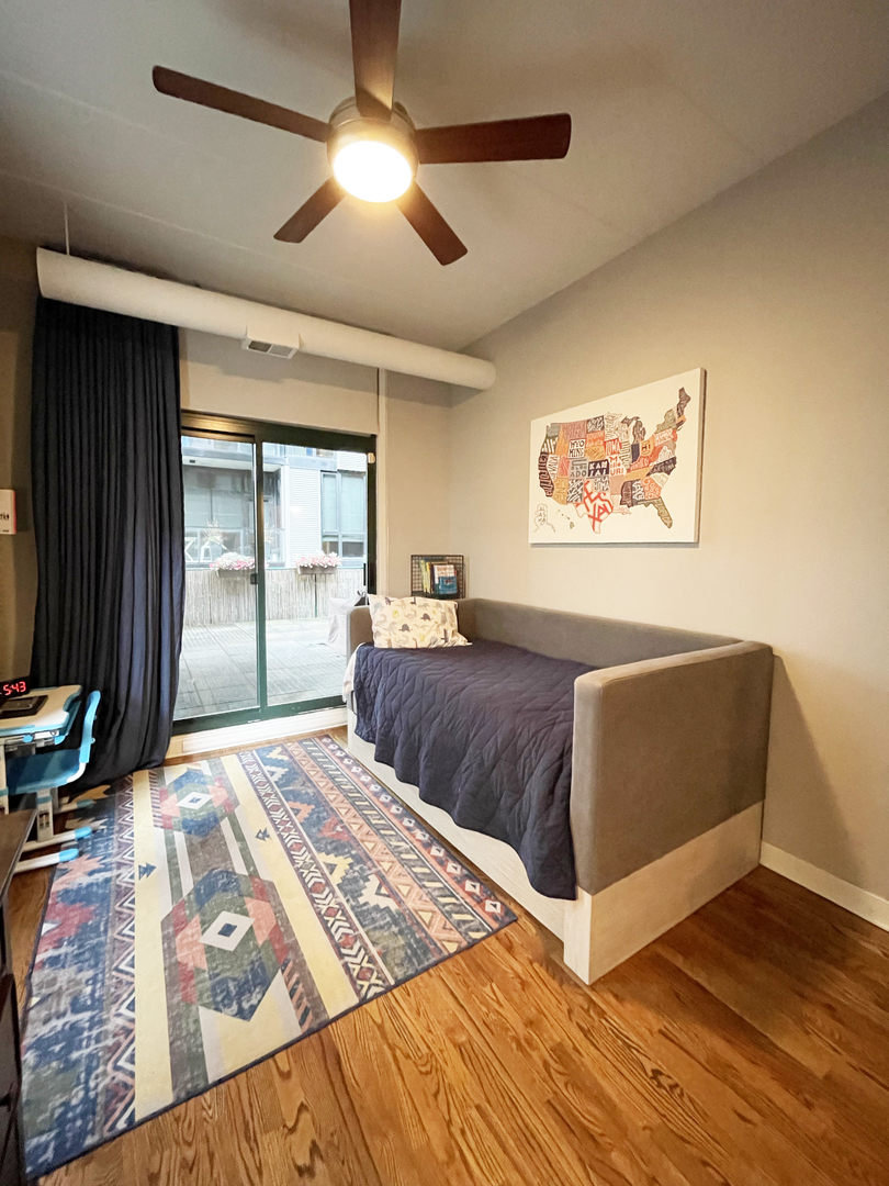 841 West Monroe Street, Unit 3A Chicago, IL 60607 - Photo 11 of 17 a bedroom with a large bed and a chandelier