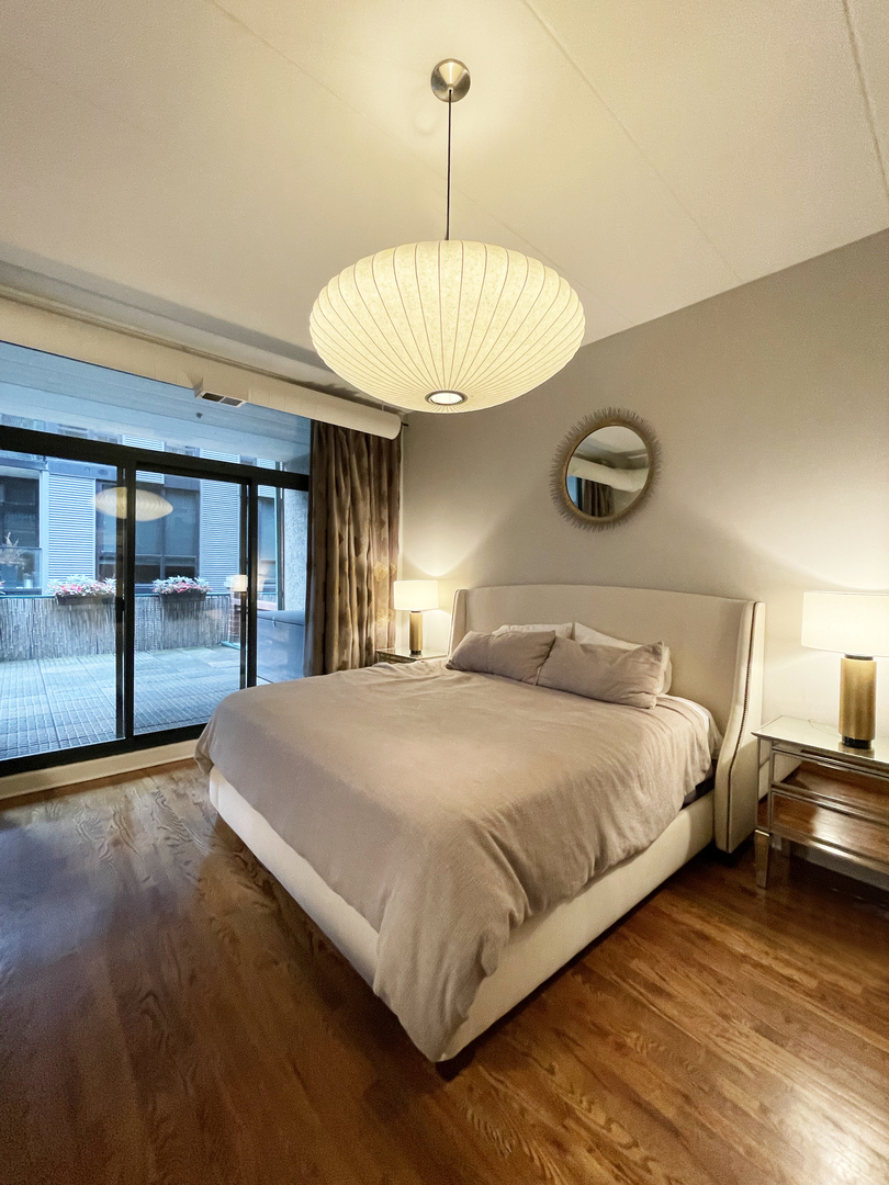 841 West Monroe Street, Unit 3A Chicago, IL 60607 - Photo 12 of 17 a bedroom with a bed and a chandelier