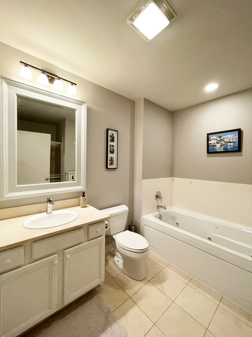 841 West Monroe Street, Unit 3A Chicago, IL 60607 - Photo 13 of 17 a bathroom with a double vanity sink mirror and toilet