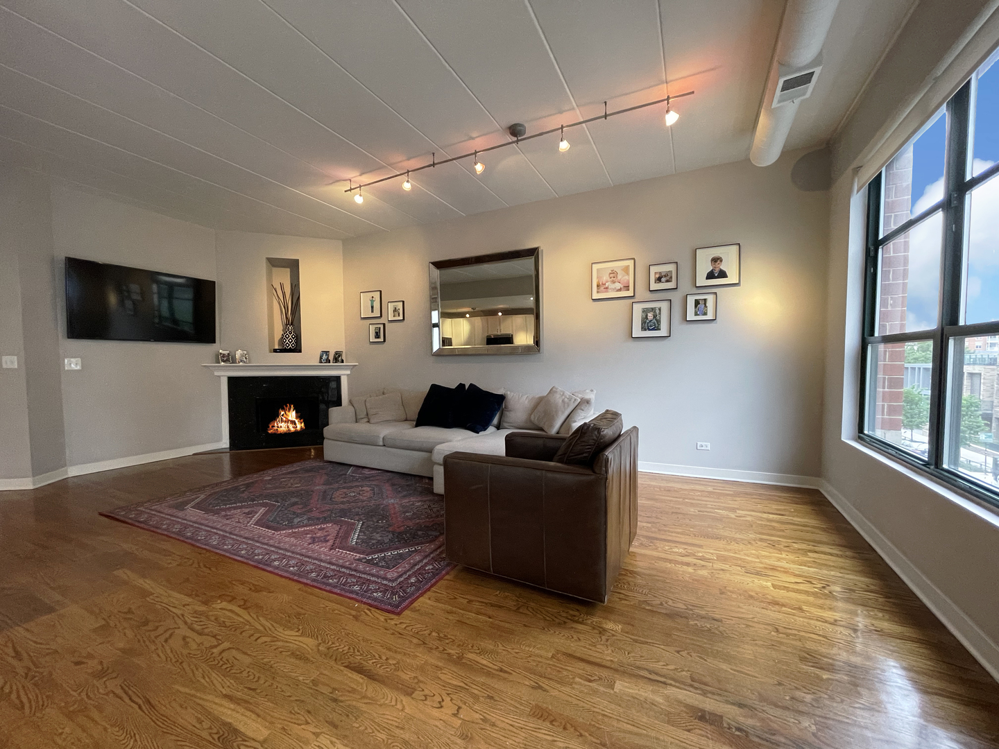 841 West Monroe Street, Unit 3A Chicago, IL 60607 - Photo 8 of 17 a living room with furniture a flat screen tv and a fireplace