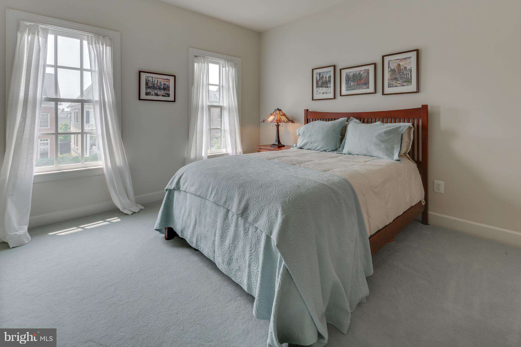 7706 Elmwood Road Fulton, MD 20759 - Photo 16 of 30 a spacious bedroom with a bed and glass window