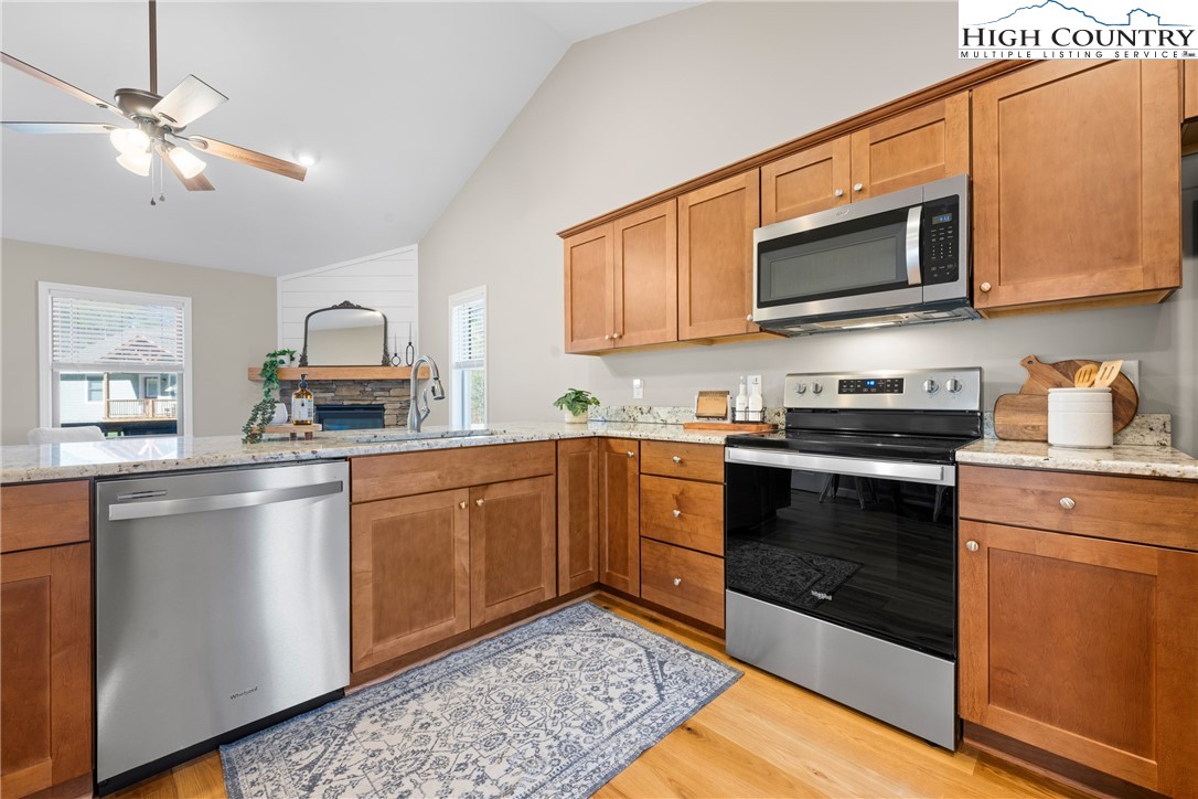 129 Pinebrook Court, Unit 4 Boone, NC 28607 - Photo 13 of 33 a kitchen with stainless steel appliances granite countertop a sink a stove top oven and cabinetry