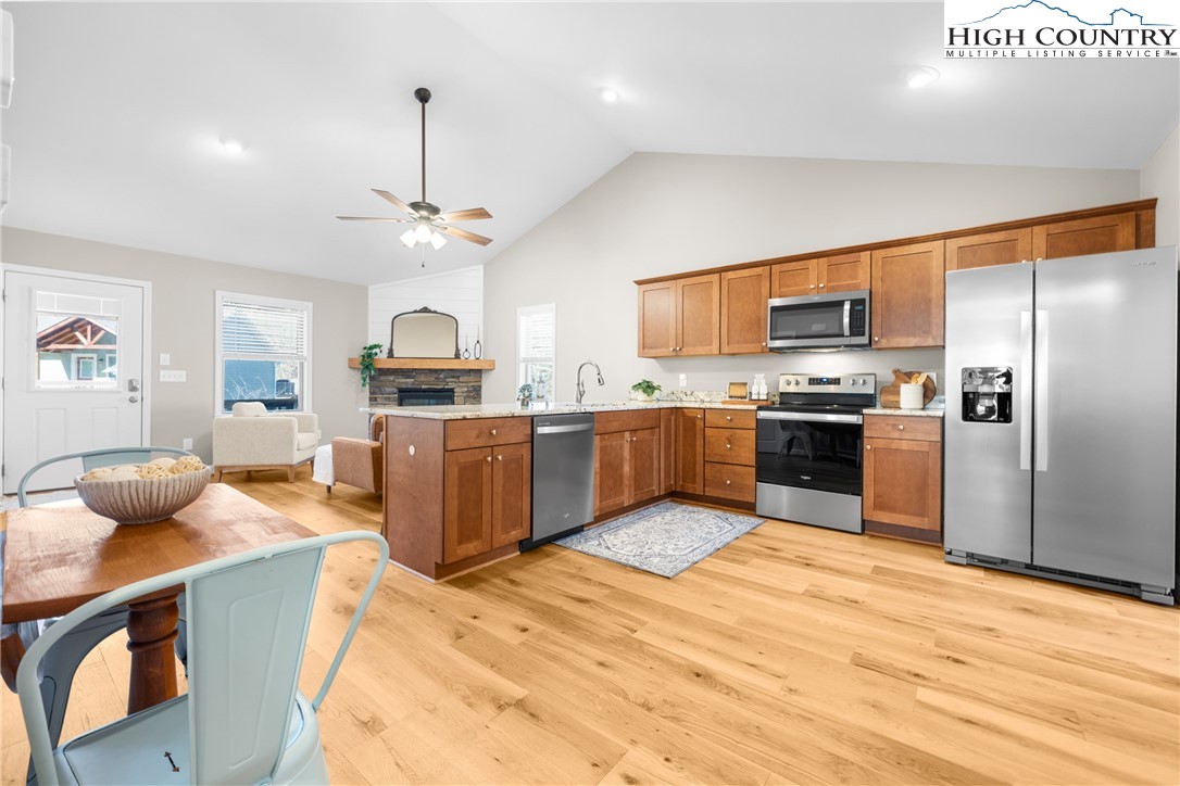 129 Pinebrook Court, Unit 4 Boone, NC 28607 - Photo 14 of 33 a kitchen with stainless steel appliances kitchen island granite countertop a sink dishwasher stove top oven and refrigerator
