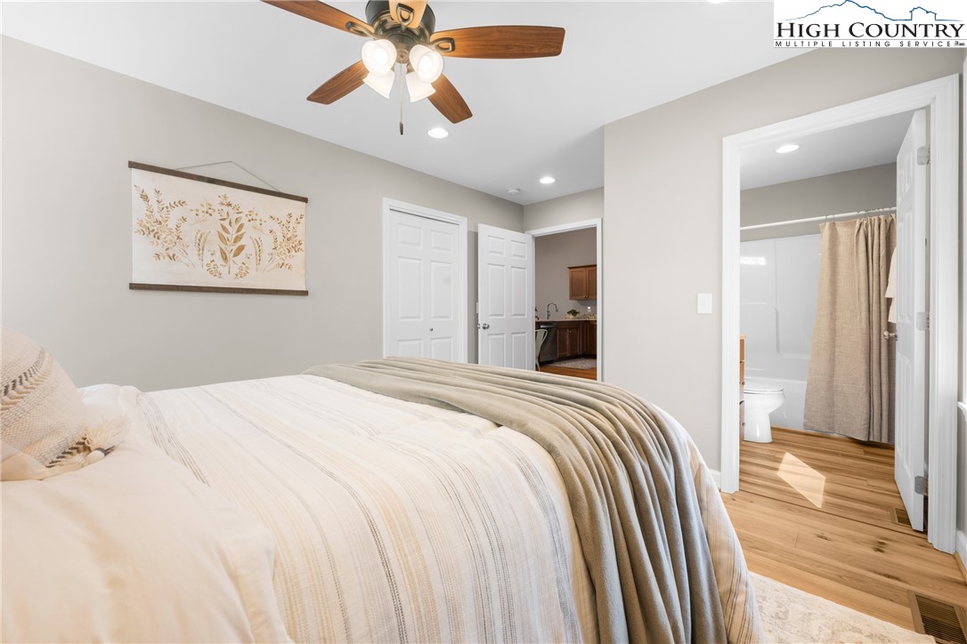 129 Pinebrook Court, Unit 4 Boone, NC 28607 - Photo 17 of 33 a bedroom with a bed and a chandelier