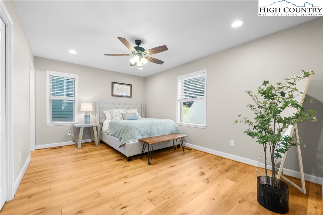 129 Pinebrook Court, Unit 4 Boone, NC 28607 - Photo 21 of 33 a bedroom with a large bed and a potted plant