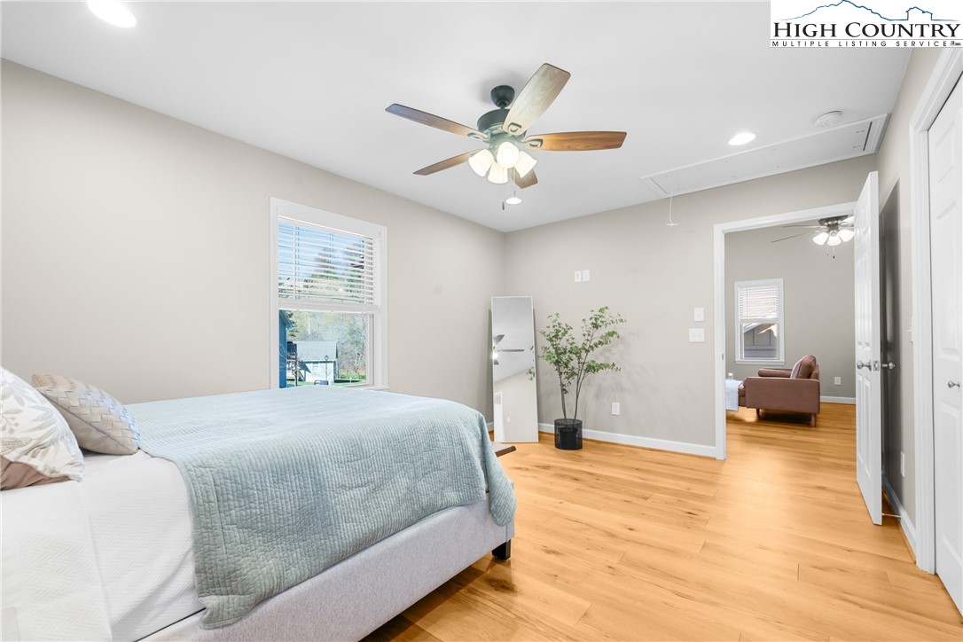 129 Pinebrook Court, Unit 4 Boone, NC 28607 - Photo 23 of 33 a spacious bedroom with a bed and a chandelier