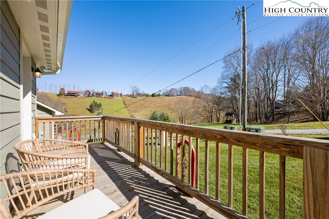 129 Pinebrook Court, Unit 4 Boone, NC 28607 - Photo 26 of 33 a view of a balcony with wooden floor