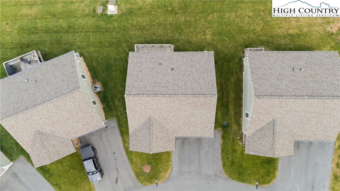 129 Pinebrook Court, Unit 4 Boone, NC 28607 - Photo 31 of 33 an aerial view of a house with swimming pool and wooden fence