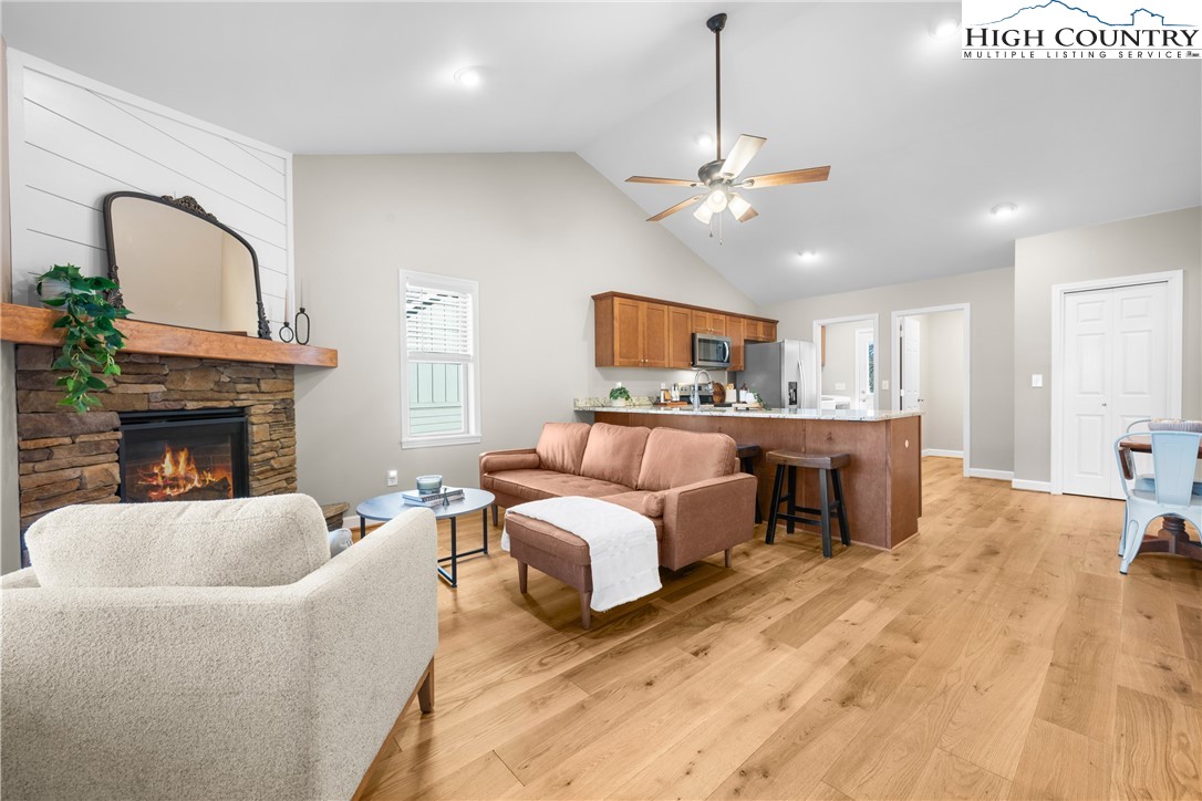 129 Pinebrook Court, Unit 4 Boone, NC 28607 - Photo 8 of 33 a living room with furniture a fireplace and a ceiling fan