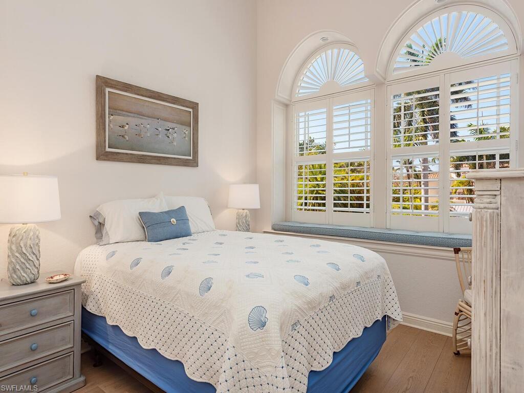 165 5th Street South, Unit 3 Naples, FL 34102 - Photo 13 of 20 a bedroom with a bed and a window