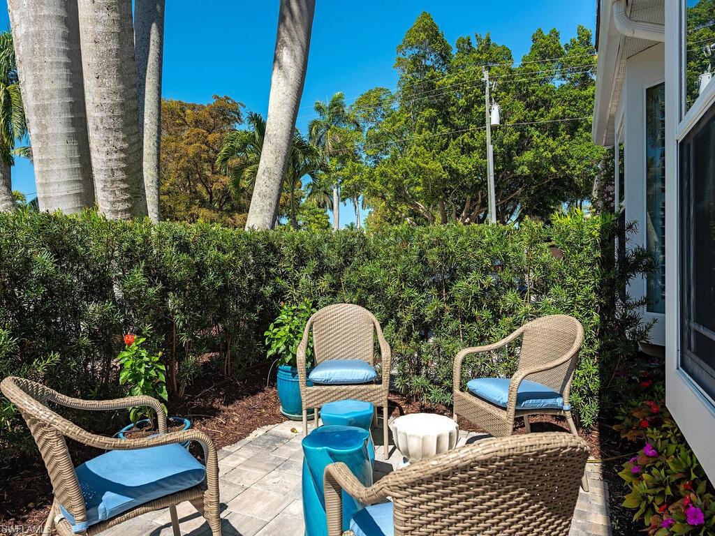 165 5th Street South, Unit 3 Naples, FL 34102 - Photo 16 of 20 a view of a chairs and table in backyard of the house