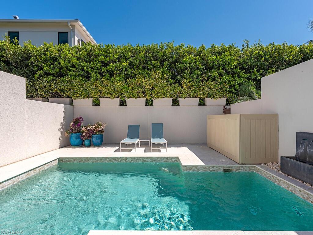 165 5th Street South, Unit 3 Naples, FL 34102 - Photo 17 of 20 a view of backyard with seating area and green space