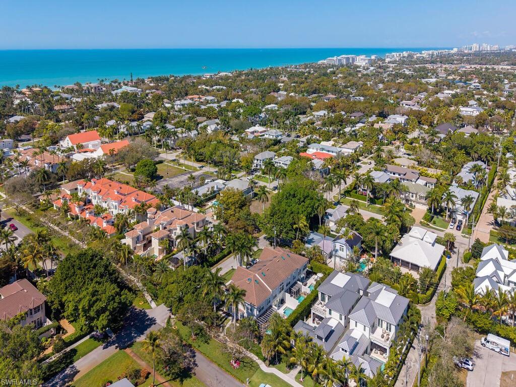 165 5th Street South, Unit 3 Naples, FL 34102 - Photo 18 of 20 an aerial view of residential houses with outdoor space and trees
