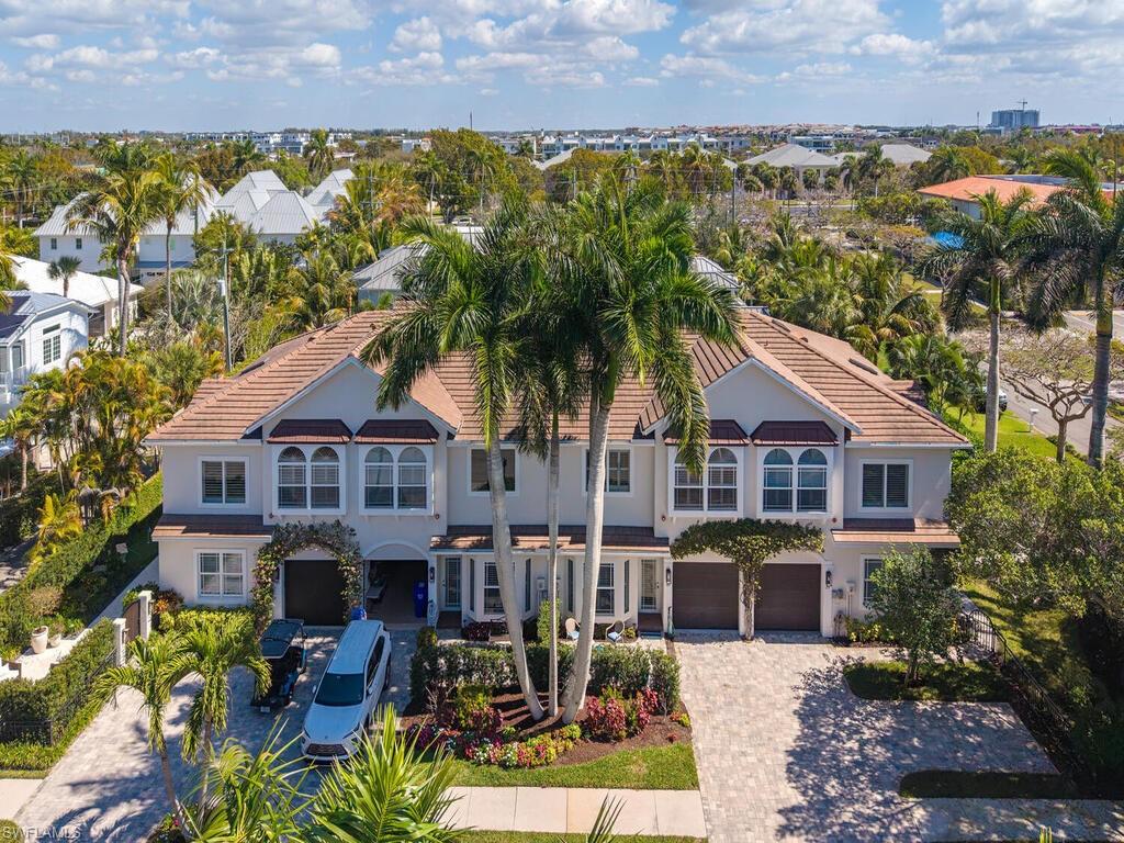165 5th Street South, Unit 3 Naples, FL 34102 - Photo 3 of 20 a front view of a house with a yard and lake view