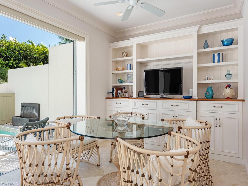 165 5th Street South, Unit 3 Naples, FL 34102 - Photo 6 of 20 a living room with furniture and a flat screen tv