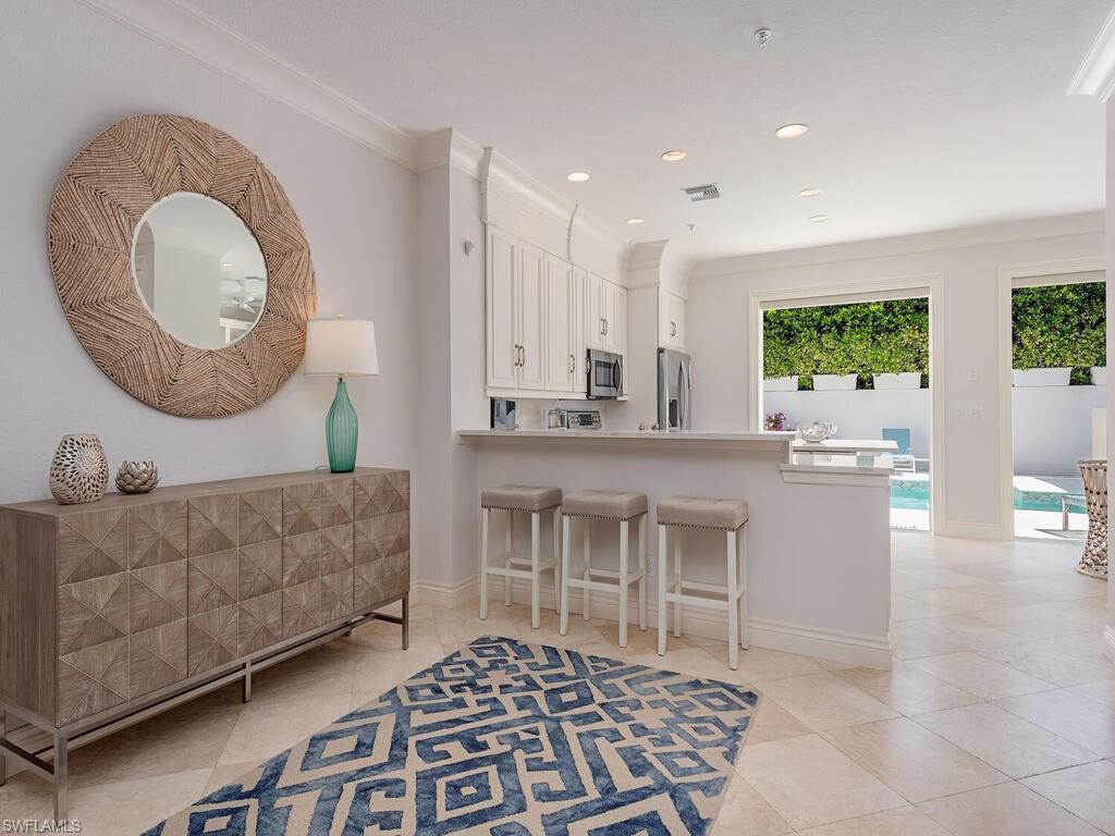 165 5th Street South, Unit 3 Naples, FL 34102 - Photo 7 of 20 a living room with furniture and a large window