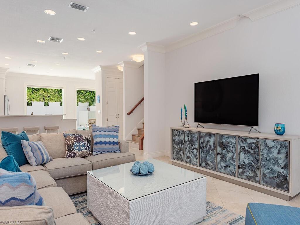 165 5th Street South, Unit 3 Naples, FL 34102 - Photo 8 of 20 a living room with furniture and a flat screen tv