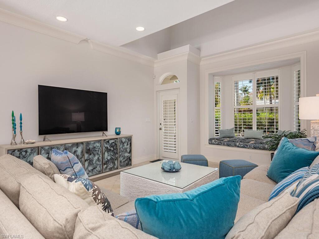 165 5th Street South, Unit 3 Naples, FL 34102 - Photo 9 of 20 a living room with furniture and a flat screen tv