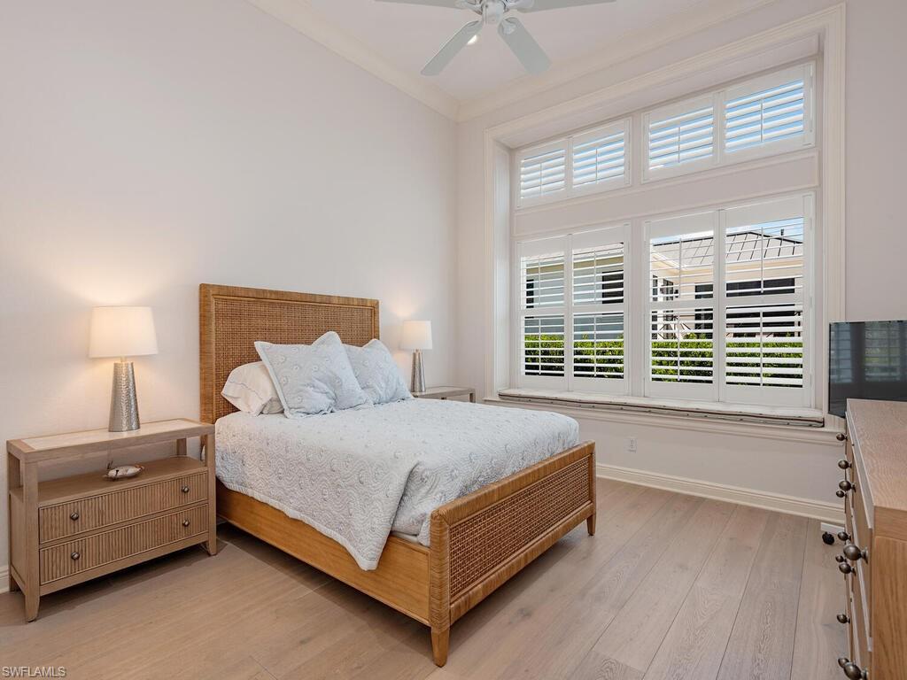 165 5th Street South, Unit 3 Naples, FL 34102 - Photo 10 of 20 a bed sitting in a bedroom next to a window