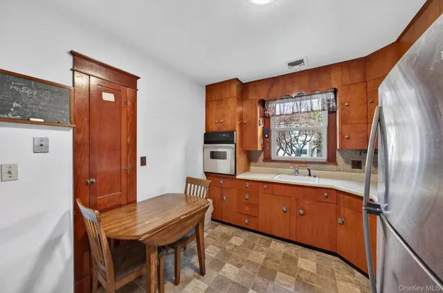a dining room with a wooden table and chairs