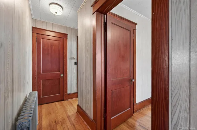 a view of hallway with wooden floor