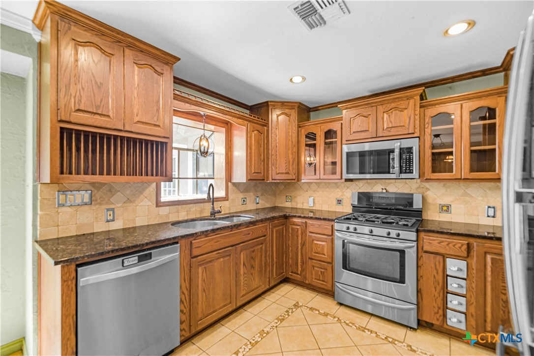 20 Hambleton Road Victoria, TX 77905 - Photo 3 of 48 a kitchen with stainless steel appliances granite countertop a stove sink and cabinets