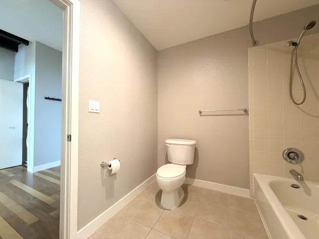 a living room with furniture a flat screen tv and a large window