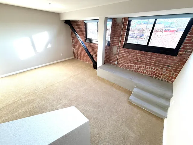 a bathroom with a granite countertop sink mirror and toilet