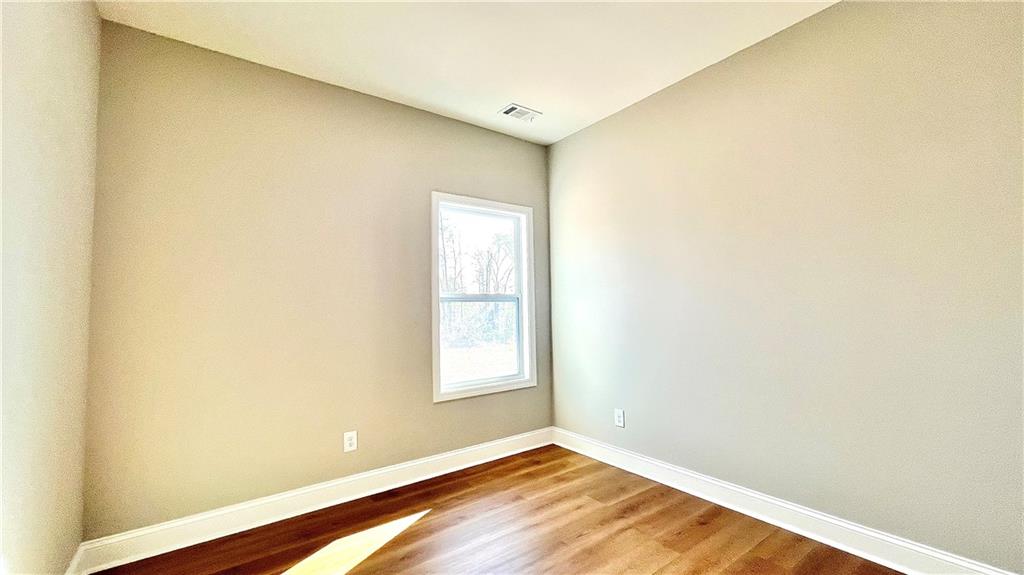 23 S Road Griffin, GA 30224 - Photo 24 of 32 a view of an empty room with wooden floor and a window