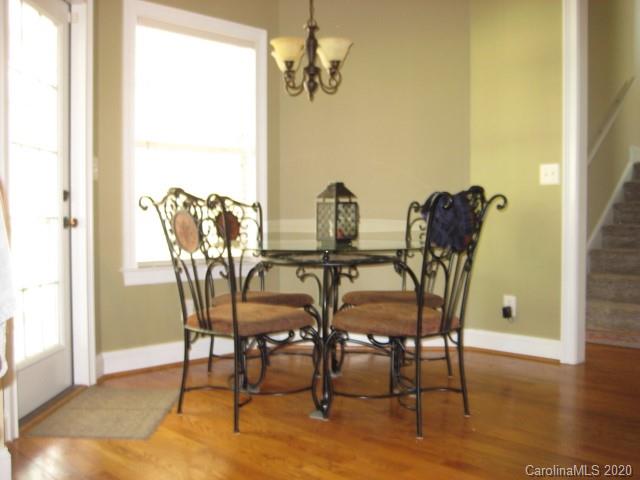 4014 Ruston Creek Road, Unit 86 Catawba, SC 29704 - Photo 14 of 48 a dining room with furniture a chandelier and wooden floor