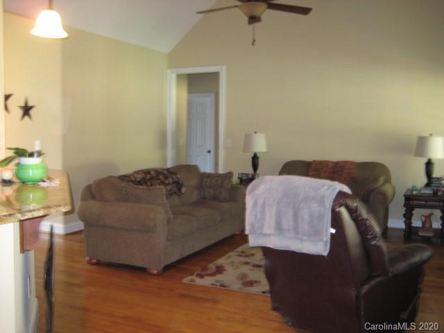 4014 Ruston Creek Road, Unit 86 Catawba, SC 29704 - Photo 20 of 48 a living room with a couch and a chandelier