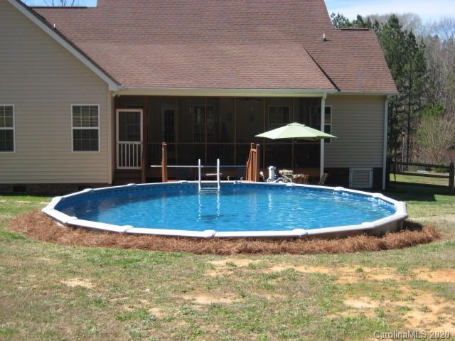 4014 Ruston Creek Road, Unit 86 Catawba, SC 29704 - Photo 45 of 48 a view of a patio with a table and chairs under an umbrella