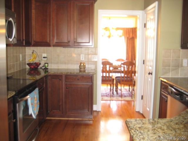 4014 Ruston Creek Road, Unit 86 Catawba, SC 29704 - Photo 9 of 48 a kitchen with a sink a refrigerator and wooden cabinets