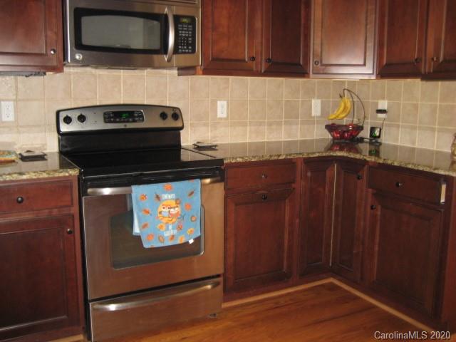 4014 Ruston Creek Road, Unit 86 Catawba, SC 29704 - Photo 10 of 48 a kitchen with stainless steel appliances granite countertop a stove and a microwave