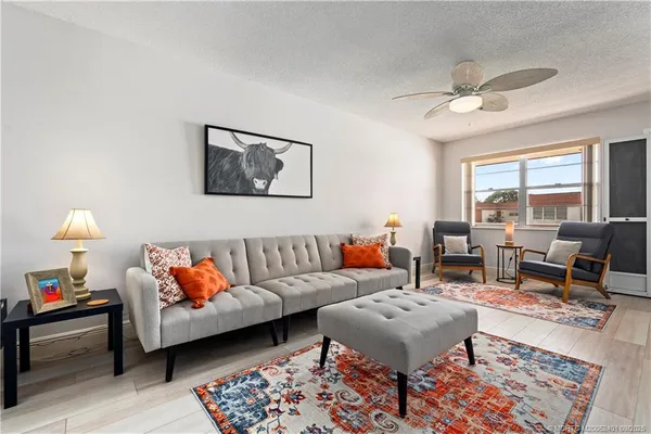 a living room with furniture and a lamp