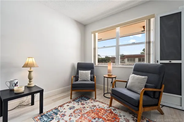 a living room with furniture and a rug