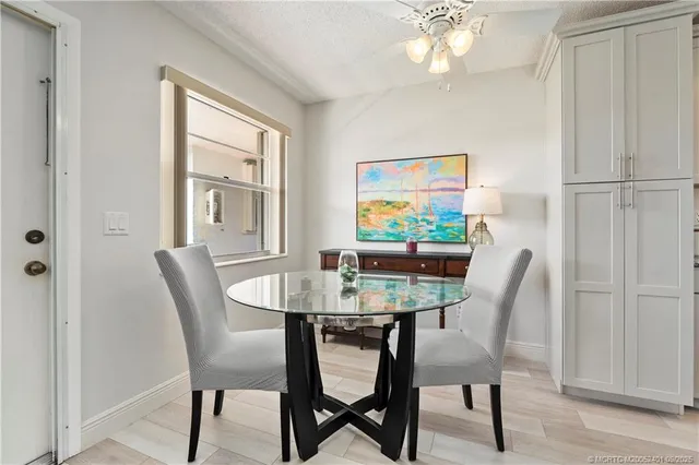 a living room with furniture and a dining table