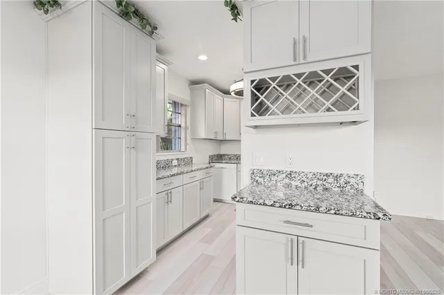 a kitchen with white cabinets and white appliances
