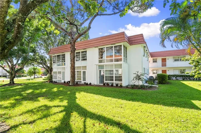 a view of a house with yard and sitting area