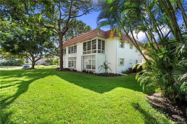 a view of a swimming pool with a yard and a fountain