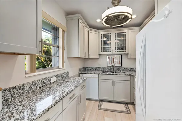 a kitchen with a stove cabinets and window
