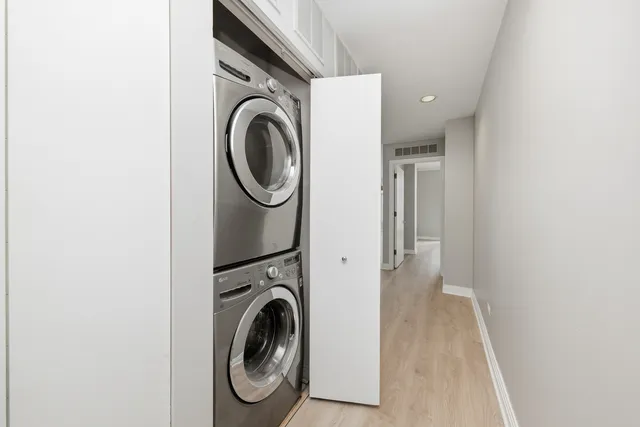 a view of a storage & utility room with dryer and washer