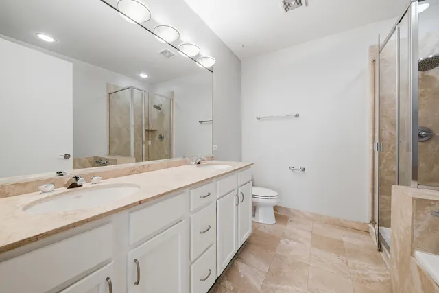 a bathroom with a double vanity sink and a mirror