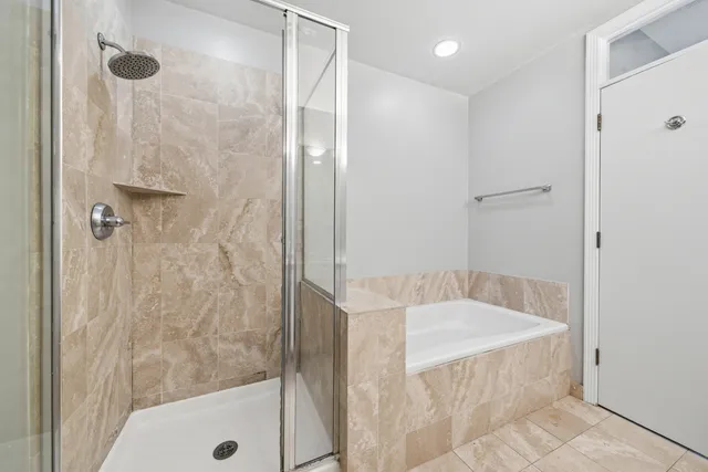 a bathroom with a tub and shower