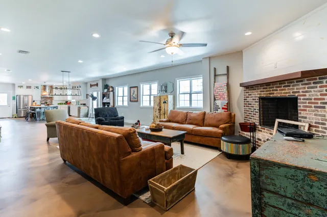 a living room with furniture and a fireplace