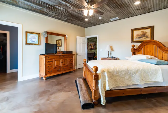 a bedroom with a bed and a television on desk