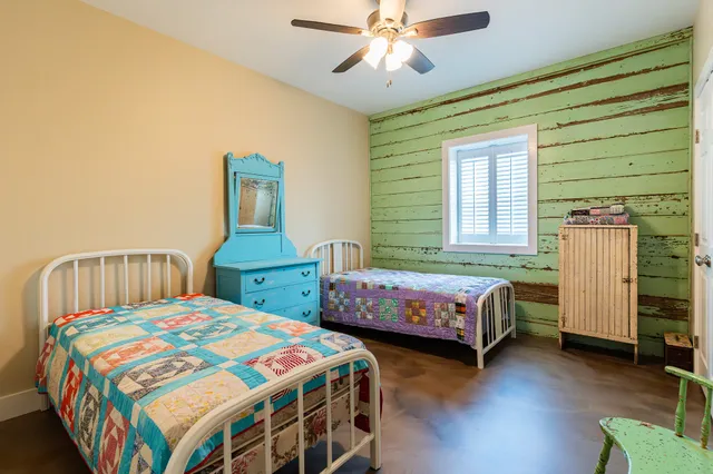 a bedroom with two beds and a window