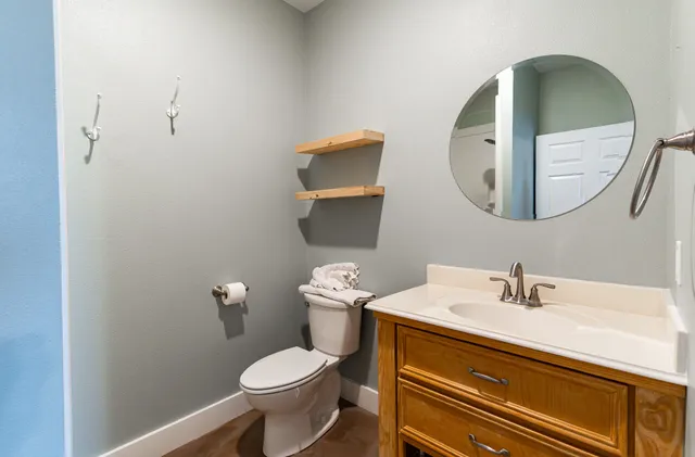 a bathroom with a sink mirror and toilet
