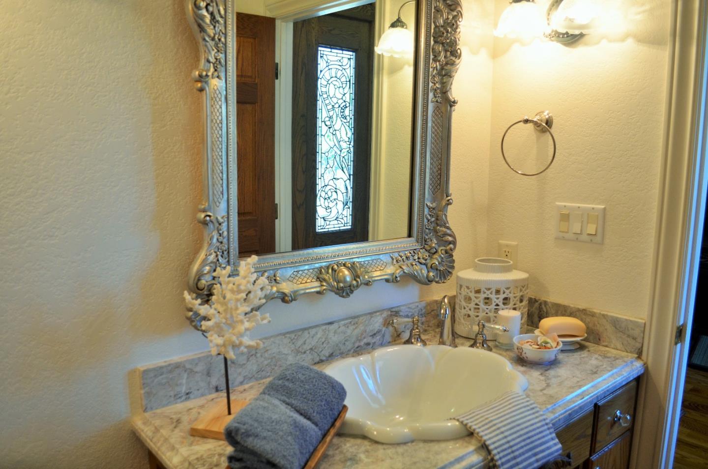 385 Tolak Road Aptos, CA 95003 - Photo 23 of 82 a bathroom with a granite countertop sink and a mirror